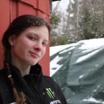 Photograph of a Girl Standing With a Shed